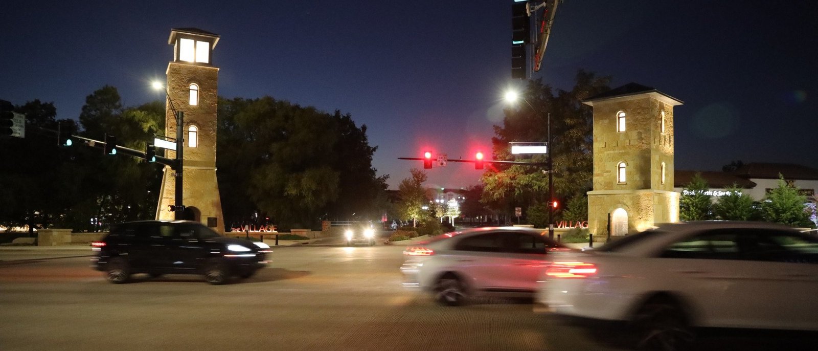 The stone gateway towers on Colleyville Boulevard lit up at night